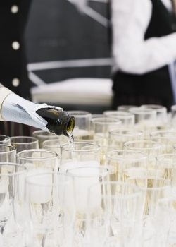 waiter pouring champagne in glasses